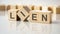 text Lien written on wood toy cubes. text for your desing