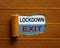 The text `lockdown exit` appearing behind torn brown paper. Business concept