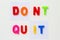 Text made by magnetic letters on a white wooden background. DONT QUIT. DO IT. Business Success