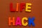 Text made in multicolored magnetic letters. LIFE HACK