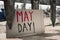 Text may day in a brown cardboard signboard