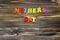 Text `mothers day` of plastic colored magnetic letters on wooden background