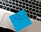 Text Never give up on sticky note. Blue sticky note on keyboard