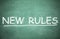 Text NEW RULES written on board