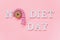 Text No diet day and abstract funny face of woman from donut with eyes and hair from centimeter tape on pink background. Concept