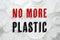 Text NO MORE PLASTIC and different disposable items on background, top view