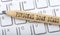 Text PERSONAL LOAN SCAMS on wooden pencil on white keyboard. Business concept