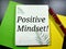 Text Positive Mindset! on a notebook with black background.