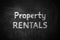 Text Property Rentals written on black chalkboard