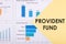 Text PROVIDENT FUND written In a yellow triangle on a white background with financial charts and graphs