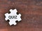 Text quiz on jigsaw puzzle against wooden background.