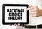 Text RATIONAL CHOICE THEORY on tablet display in businessman hands on the white background. Business concept