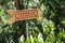 Text reception on a wooden board near tropical hotel in Bali island, Indonesia. Reception wooden sign inscription in the asian