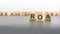 text ROA on wooden cubes. abbreviation of \\\'Return on Assets\\\'. square wood blocks. top view, flat lay