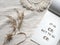 Text It's OK not to be OK in block note. Envelope, macrame, pampas grass.. Simple minimal flat lay on ivory textile with