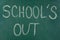 Text School`s Out written on chalkboard. Summer holidays