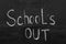 Text School`s Out written on chalkboard. Summer holidays