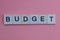 Text from a short gray word budget made of small wooden letters