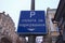 Text on sign: Pay for parking here. Rectangular blue plate with white text. Concept of parking in big city