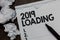 Text sign showing 2019 Loading. Conceptual photo Advertising the upcoming year Forecasting the future event Marker over notebook c