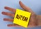 Text sign showing Autism. Conceptual photo Autism Awareness conducted by social committee around the globe written on Yellow Stick