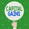 Text sign showing Capital Gains. Conceptual photo Bonds Shares Stocks Profit Income Tax Investment Funds Male Hu analysis Hand