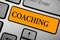 Text sign showing Coaching. Conceptual photo person supports client in achieving specific personal goal Keyboard orange key Intent