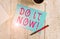 Text sign showing Do It Now. Conceptual photo not hesitate and start working or doing stuff right away Stationary placed