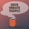 Text sign showing Drive Website Traffic. Conceptual photo Increase the number of visitors to business website Mug photo Cup of Hot