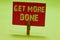 Text sign showing Get More Done. Conceptual photo Checklist Organized Time Management Start Hardwork Act Clothespin holding red pa