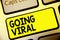 Text sign showing Going Viral. Conceptual photo image video or link that spreads rapidly through population Keyboard yellow key In