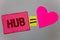 Text sign showing Hub. Conceptual photo Device connecting computers Center of Wheel Activities Transportation Paper Heart equal si