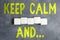 Text sign showing Keep Calm And. Word for motivational poster produced by British government Stack of Sample Cube