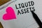 Text sign showing Liquid Assets. Conceptual photo Cash and Bank Balances Market Liquidity Deferred Stock Squared notebook paper ri