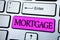 Text sign showing Mortgage. Conceptual photo Conditional right of property to lender as warranty from loan written on Pink Key But