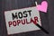 Text sign showing Most Popular. Conceptual photo Liked Followed Enjoyed by majority of the people in a society White page red bord