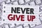 Text sign showing Never Give Up. Conceptual photo Be persistent motivate yourself succeed never look back written on Notebook pape