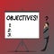 Text sign showing Objectives. Conceptual photo Goals planned to be achieved Desired targets Company missions Businessman