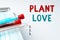 Text sign showing Plant Love. Business idea a symbol of emotional love, care and support showed to others Writing