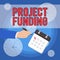Text sign showing Project Funding. Conceptual photo paying for start up in order make it bigger and successful Male Hand
