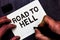 Text sign showing Road To Hell. Conceptual photo Extremely dangerous passageway Dark Risky Unsafe travel Man holding marker notebo