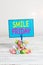 Text sign showing Smile Friday. Conceptual photo used to express happiness from beginning of fresh week Reminder pile