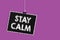 Text sign showing Stay Calm. Conceptual photo Maintain in a state of motion smoothly even under pressure Hanging blackboard messag