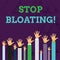 Text sign showing Stop Bloating. Conceptual photo to end the condition where your belly feels full and tight Hands of