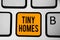 Text sign showing Tiny Homes. Conceptual photo houses contain one room only or two and small entrance Cheap Keyboard orange key In