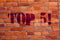 Text sign showing Top 5. Conceptual photo The best ones Winners Most Popular Bestsellers Brick Wall art like Graffiti