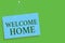 Text sign showing Welcome Home. Conceptual photo Expression Greetings New Owners Domicile Doormat Entry Blue board wall message co