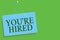 Text sign showing You re are Hired. Conceptual photo New Job Employed Newbie Enlisted Accepted Recruited Blue board wall message c