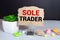 text sole trader on stickers on the diary with office tools