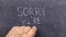 Text sorry we`re closed written with chalk on old blackboard.